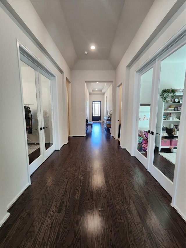 corridor featuring recessed lighting, french doors, lofted ceiling, and wood finished floors