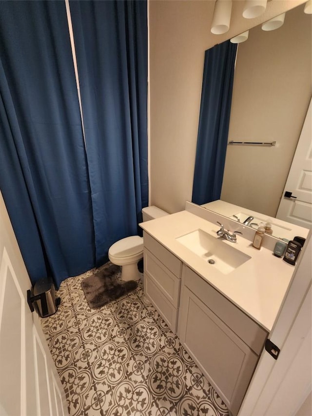 full bath with tile patterned flooring, toilet, and vanity