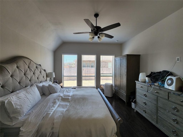 bedroom with ceiling fan, lofted ceiling, and dark wood-style flooring