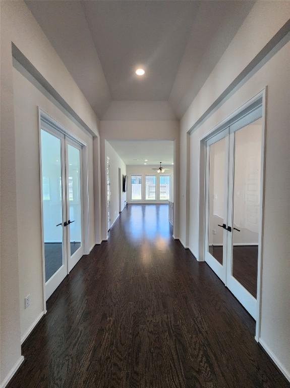 522 Jefferson Dr, Kyle, TX 78640 - hall with french doors, dark wood finished floors, and vaulted ceiling