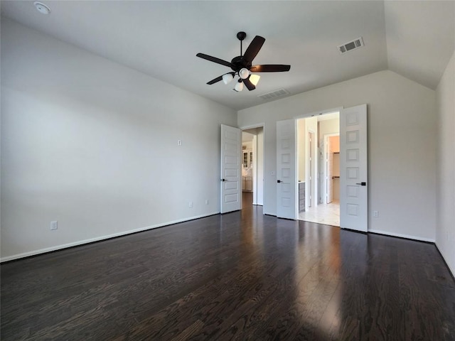 522 Jefferson Dr, Kyle, TX 78640 - unfurnished bedroom with wood finished floors, a ceiling fan, vaulted ceiling, and ensuite bathroom