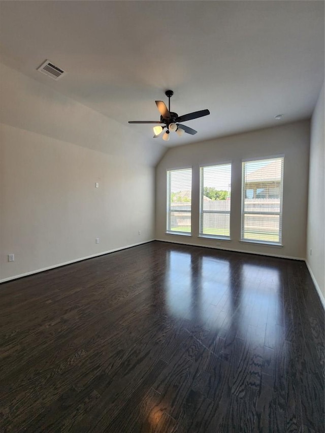 522 Jefferson Dr, Kyle, TX 78640 - empty room featuring dark wood-style floors, a ceiling fan, and vaulted ceiling