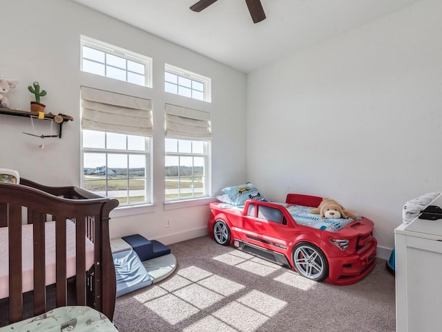 bedroom featuring a ceiling fan, baseboards, and carpet flooring