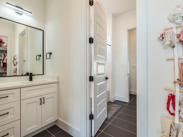 bathroom featuring baseboards, vanity, and tile patterned floors