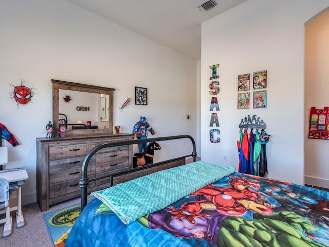 bedroom with vaulted ceiling, carpet floors, visible vents, and baseboards