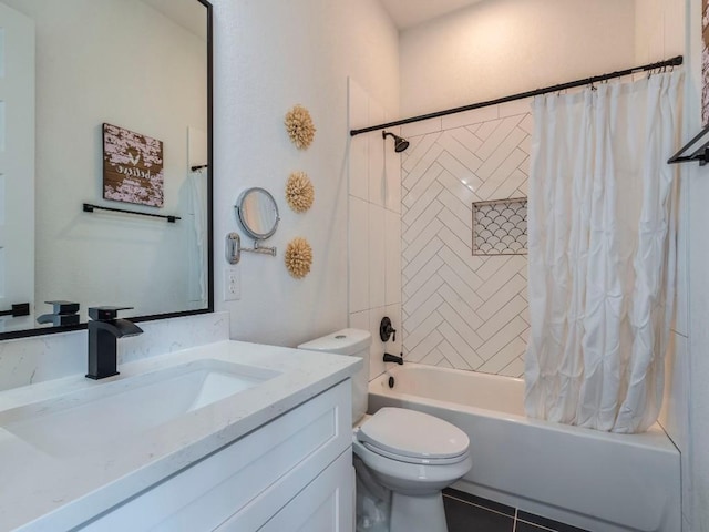 bathroom featuring toilet, shower / bath combo with shower curtain, and vanity