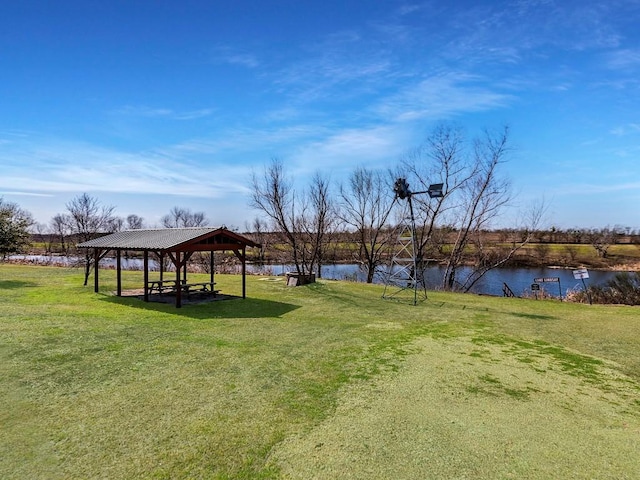 view of community featuring a gazebo, a yard, and a water view