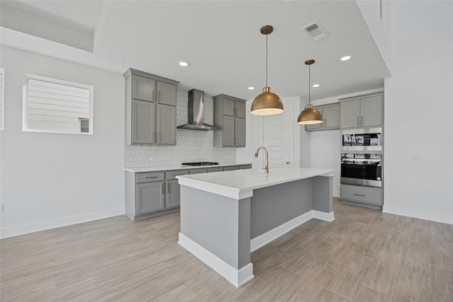 216 Echo Pass, Liberty Hill, TX 78642 - kitchen featuring oven, wall chimney range hood, gray cabinetry, gas cooktop, and tasteful backsplash