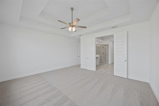216 Echo Pass, Liberty Hill, TX 78642 - unfurnished room featuring a tray ceiling, carpet floors, baseboards, and a ceiling fan
