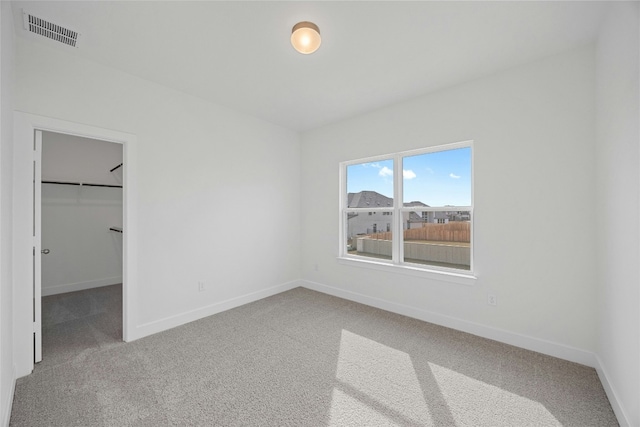 216 Echo Pass, Liberty Hill, TX 78642 - unfurnished bedroom with carpet flooring, a walk in closet, and a closet
