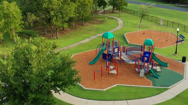 community playground featuring fence and a lawn