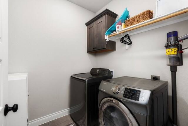 laundry room with washer and dryer, cabinet space, baseboards, and tile patterned floors