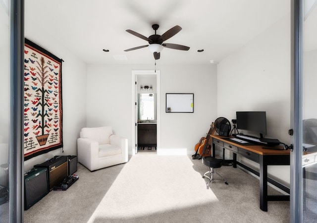 carpeted office with ceiling fan and visible vents