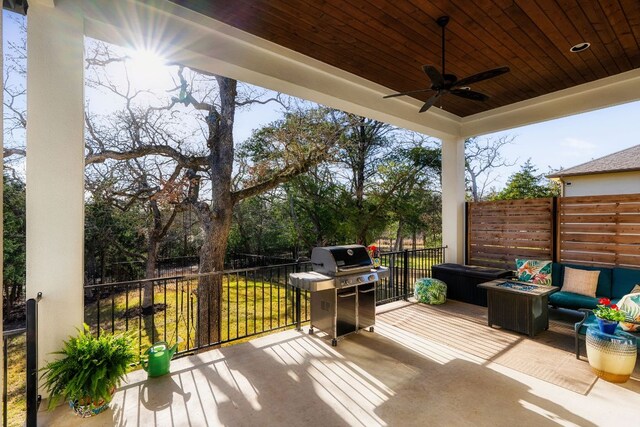 wooden deck with an outdoor living space, area for grilling, and a ceiling fan