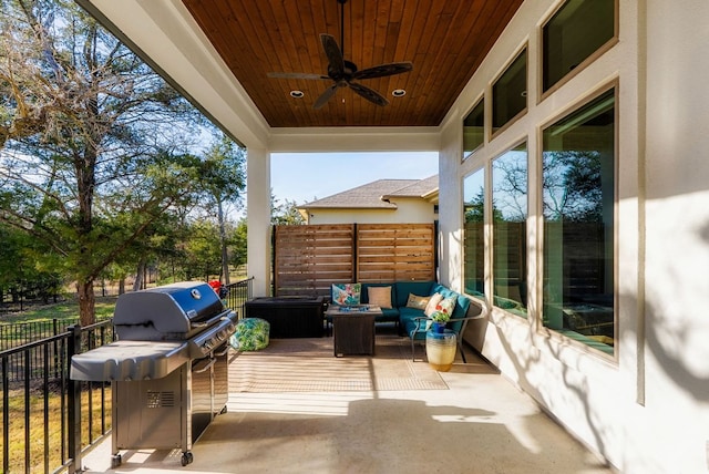 wooden terrace featuring a ceiling fan, outdoor lounge area, and fence