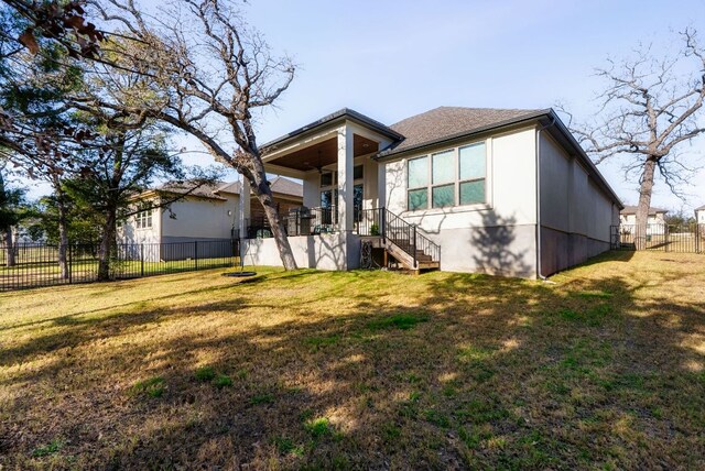 view of front of property with a shingled roof, fence, and a front yard