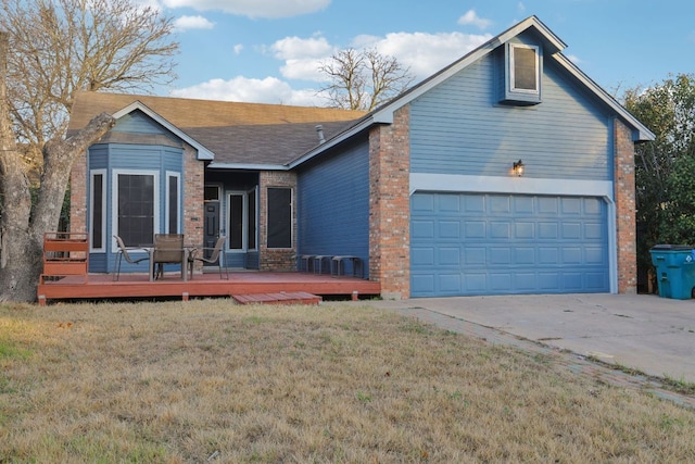 view of front of home with a garage, a front lawn, a wooden deck, and brick siding