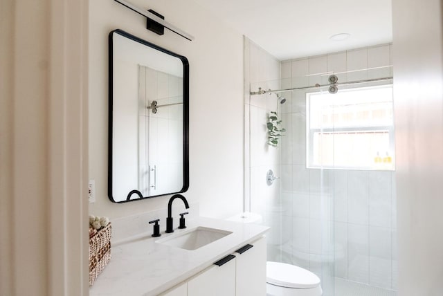 full bath with a shower stall, toilet, and vanity