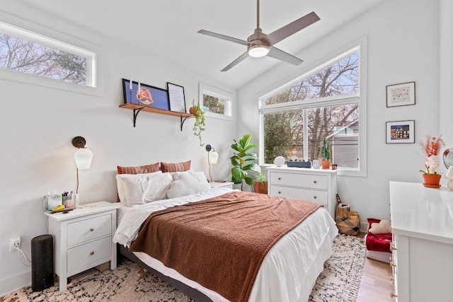 bedroom featuring lofted ceiling and light wood-style flooring