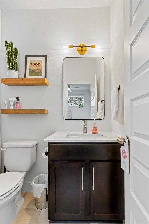 half bathroom featuring toilet and vanity