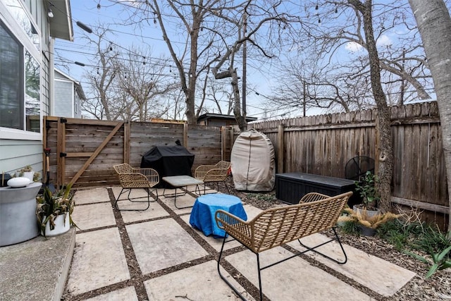 view of patio with a fenced backyard and a grill