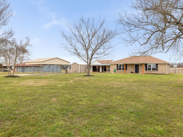 view of yard featuring fence and a detached carport