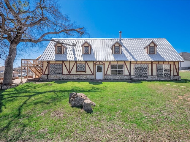 805 Wanta Hideaway, Spicewood, TX 78669 - rear view of property with stucco siding, stone siding, a yard, and metal roof