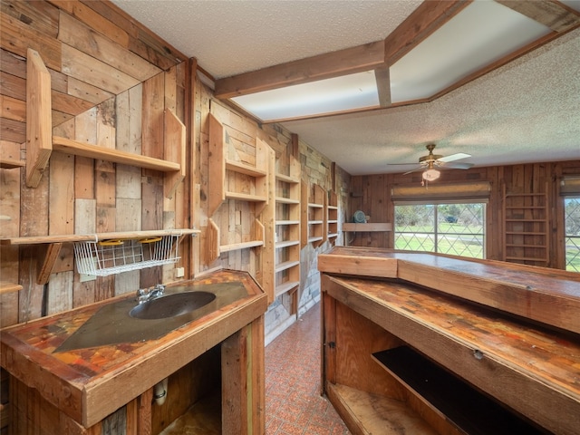 805 Wanta Hideaway, Spicewood, TX 78669 - interior space with a textured ceiling, wood walls, a sink, and ceiling fan