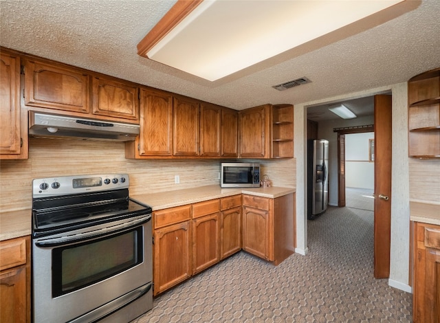 805 Wanta Hideaway, Spicewood, TX 78669 - kitchen featuring stainless steel appliances, under cabinet range hood, open shelves, brown cabinetry, and a textured ceiling