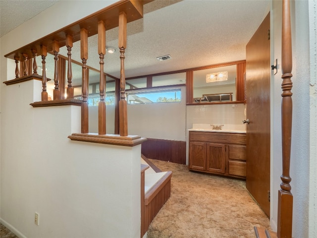 805 Wanta Hideaway, Spicewood, TX 78669 - staircase featuring carpet and a textured ceiling