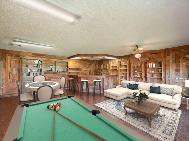 805 Wanta Hideaway, Spicewood, TX 78669 - rec room with wooden walls, a textured ceiling, billiards, a ceiling fan, and bar