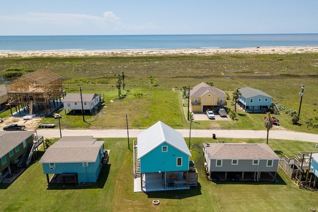 drone / aerial view with a water view and a view of the beach