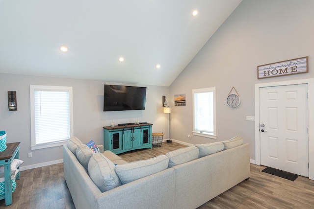 living area featuring recessed lighting, baseboards, and wood finished floors