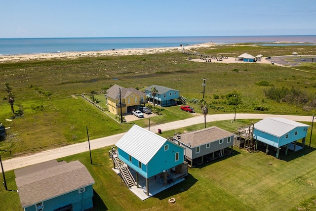 aerial view featuring a water view and a beach view