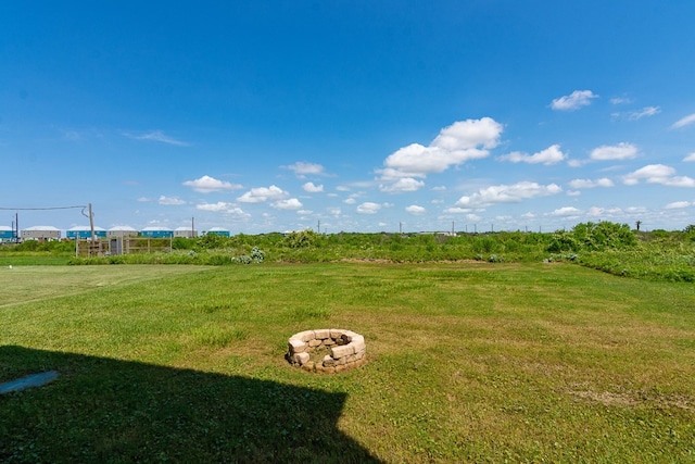 view of yard with a fire pit