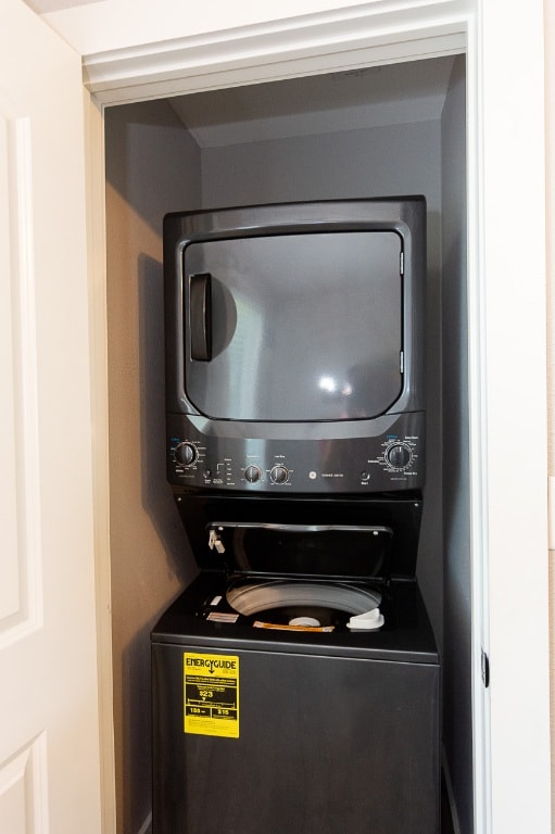 washroom featuring laundry area and stacked washer / dryer