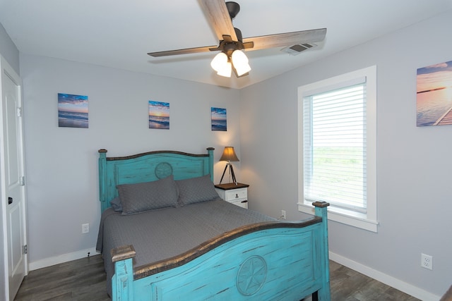 bedroom featuring dark wood-type flooring, visible vents, and baseboards