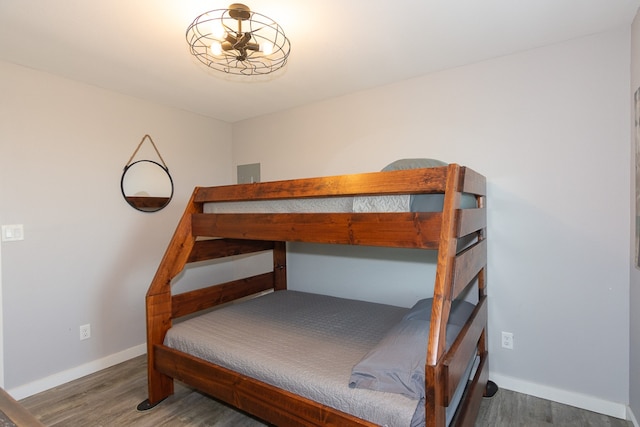 bedroom featuring wood finished floors and baseboards