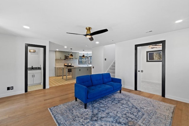 2702 S 2nd St Unit 1 & 2, Austin, TX 78704 - sitting room featuring light wood finished floors, stairway, ceiling fan, and recessed lighting