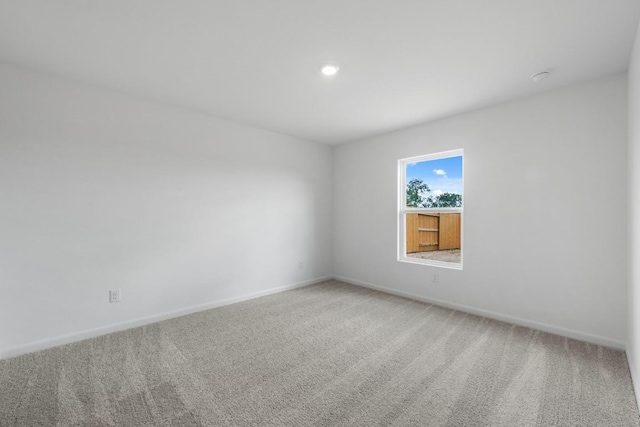 carpeted spare room with baseboards