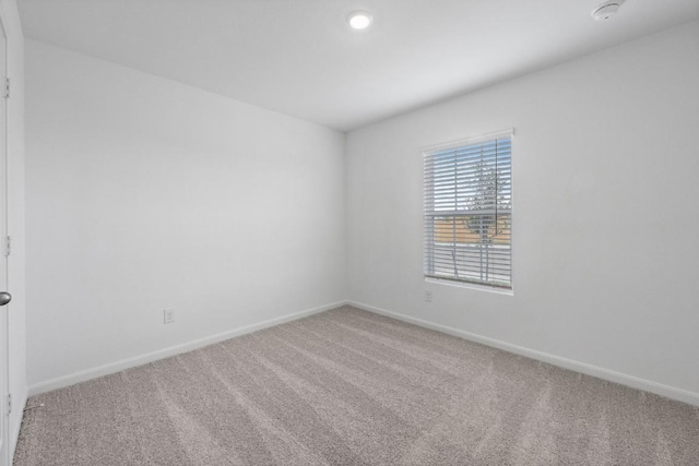 spare room with carpet floors and baseboards