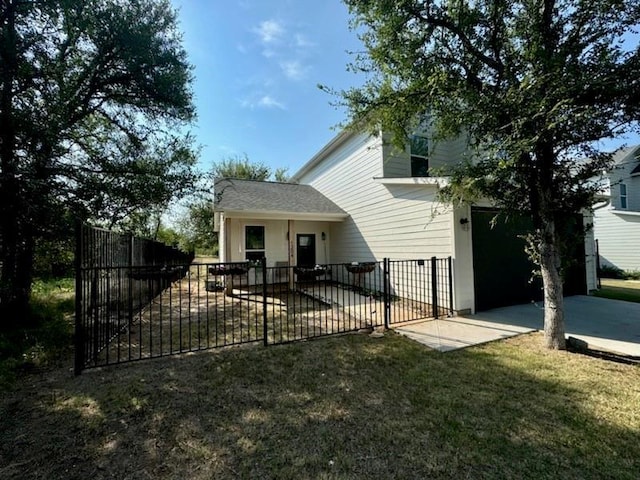 back of house with a patio, a lawn, and fence