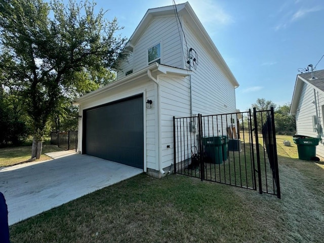 view of home's exterior featuring a garage, a yard, fence, and driveway