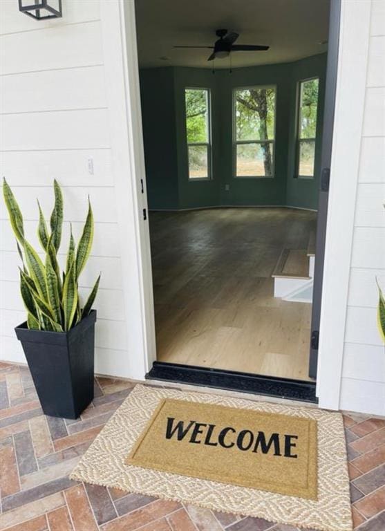 view of exterior entry featuring a ceiling fan