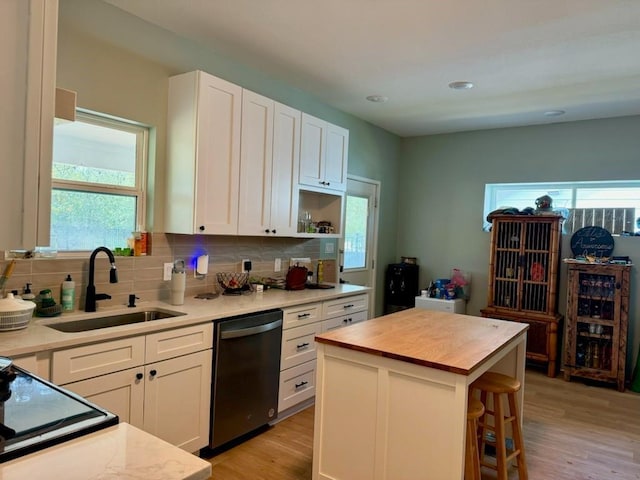 kitchen featuring a sink, white cabinetry, wooden counters, dishwasher, and tasteful backsplash