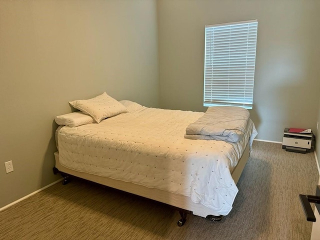 carpeted bedroom featuring baseboards