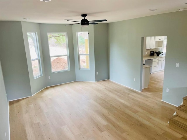 spare room featuring ceiling fan and light wood-style flooring