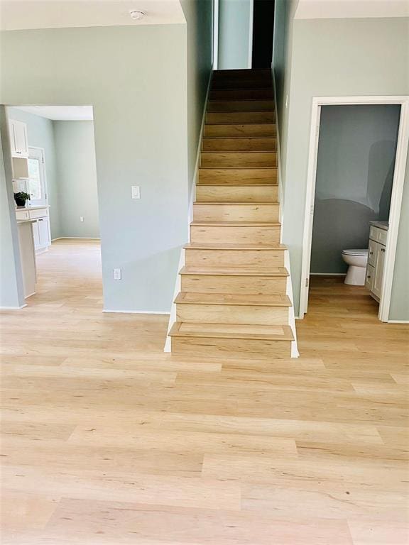 stairs featuring wood finished floors