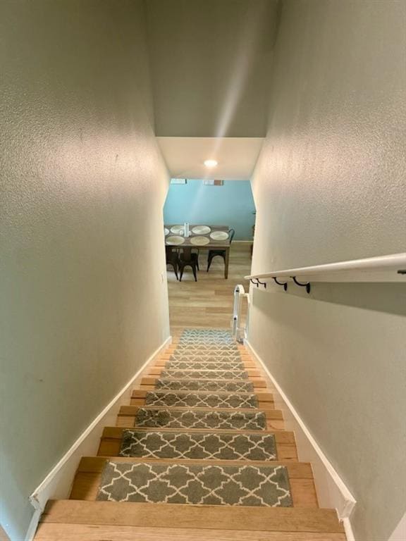 stairs with baseboards and wood finished floors