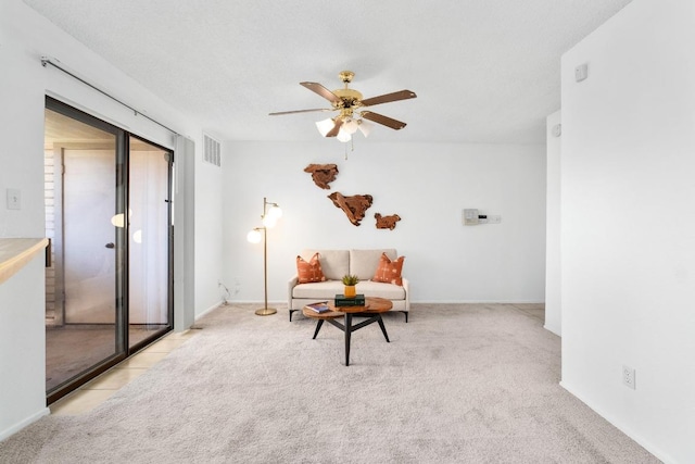 sitting room featuring light carpet, ceiling fan, and visible vents